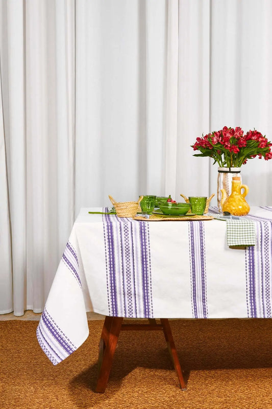 Mantel de estilo alpujarreño con rayas verticales en tonos malva sobre fondo blanco, textil rústico de algodón.