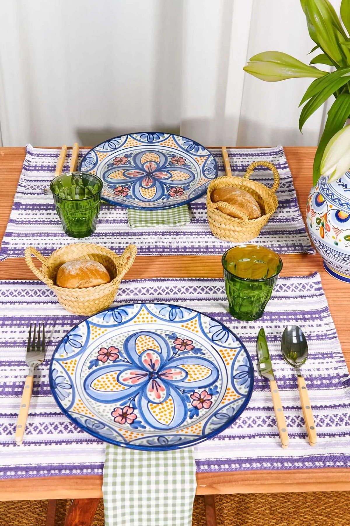 Pack of 2 rectangular mauve and white striped placemats with geometric patterns, set on a wooden table.