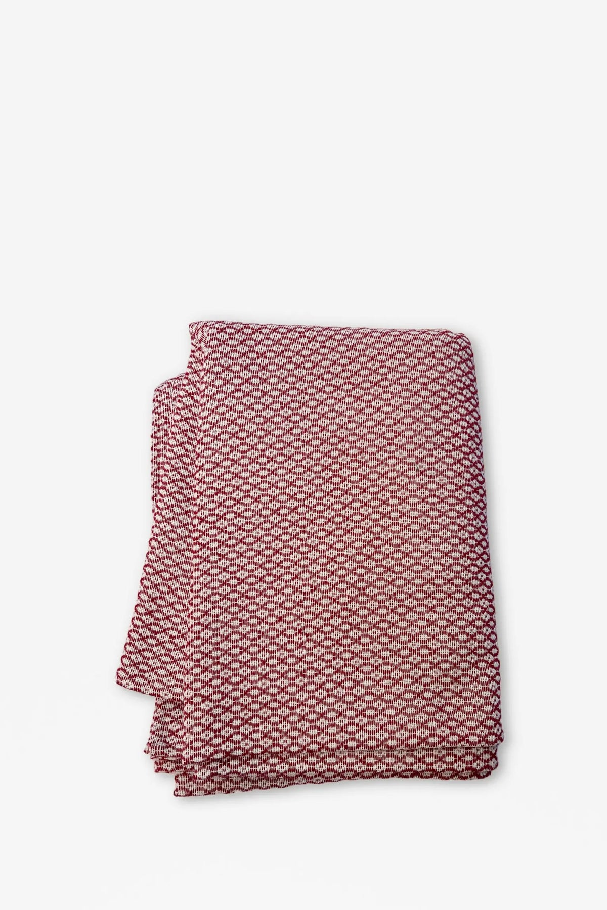 Folded tablecloth with a burgundy and white textured, geometric bird's-eye pattern on a plain background.