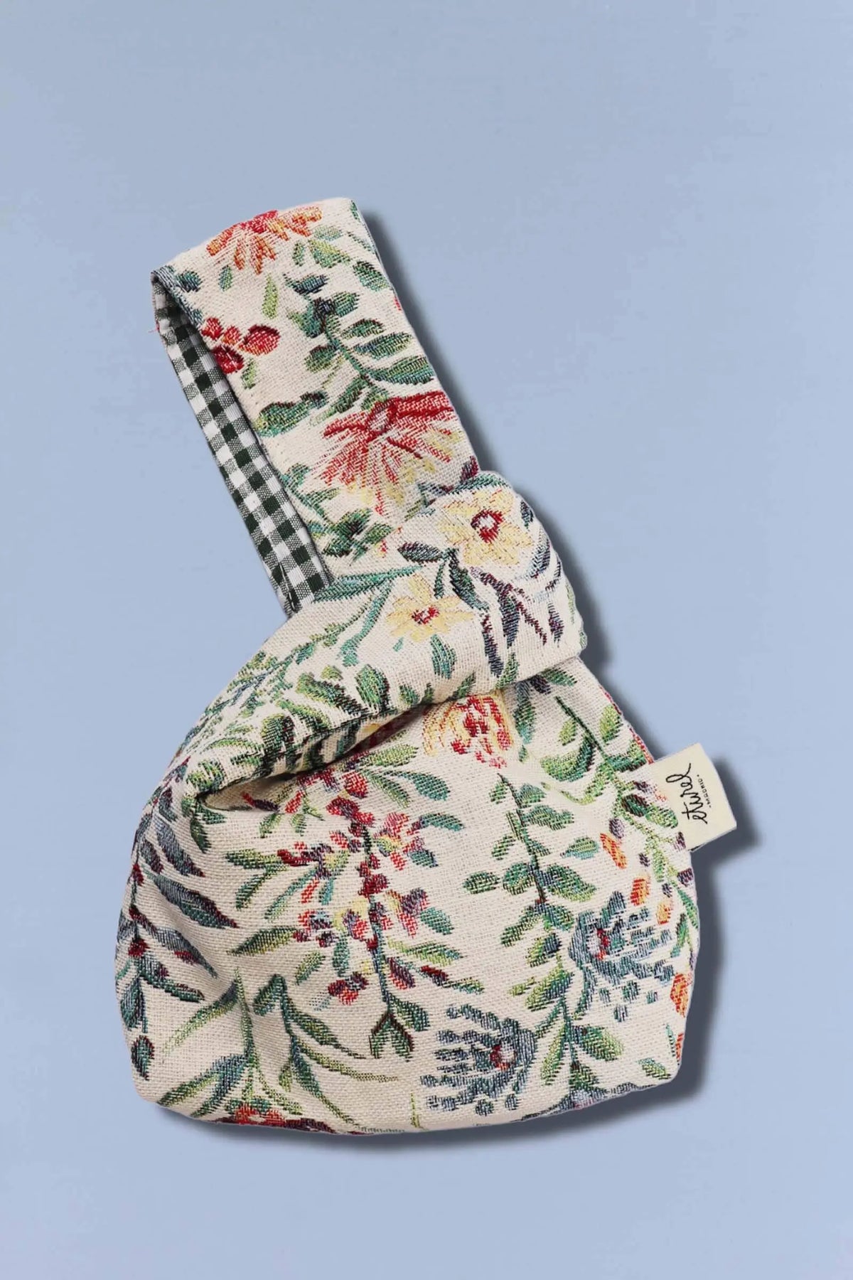 Bolso hatillo mini de tela jacquard con estampado de flores azaleas y forro interior de cuadros vichy.