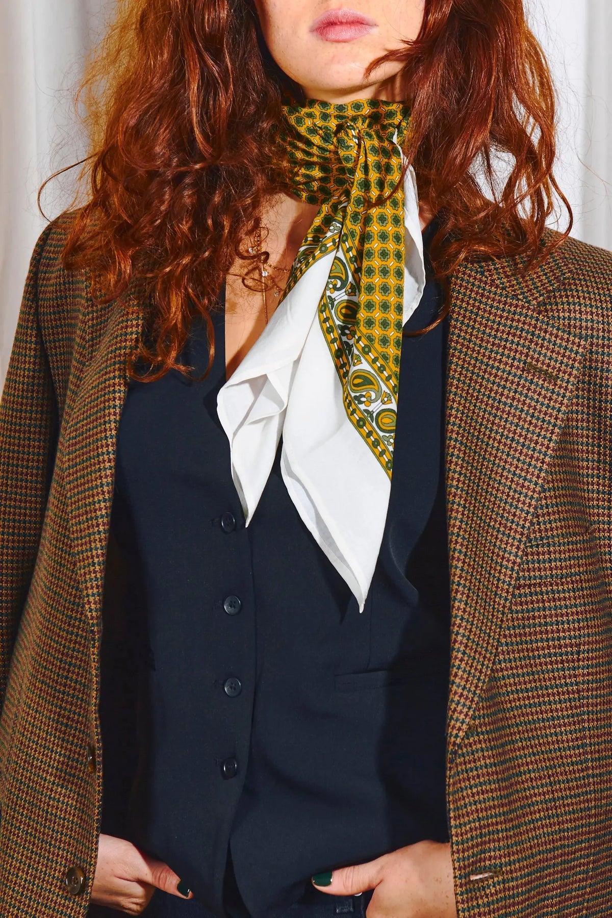 Pañuelo aragonés de algodón con estampado floral y geométrico en tonos ocre, verde y blanco anudado al cuello.