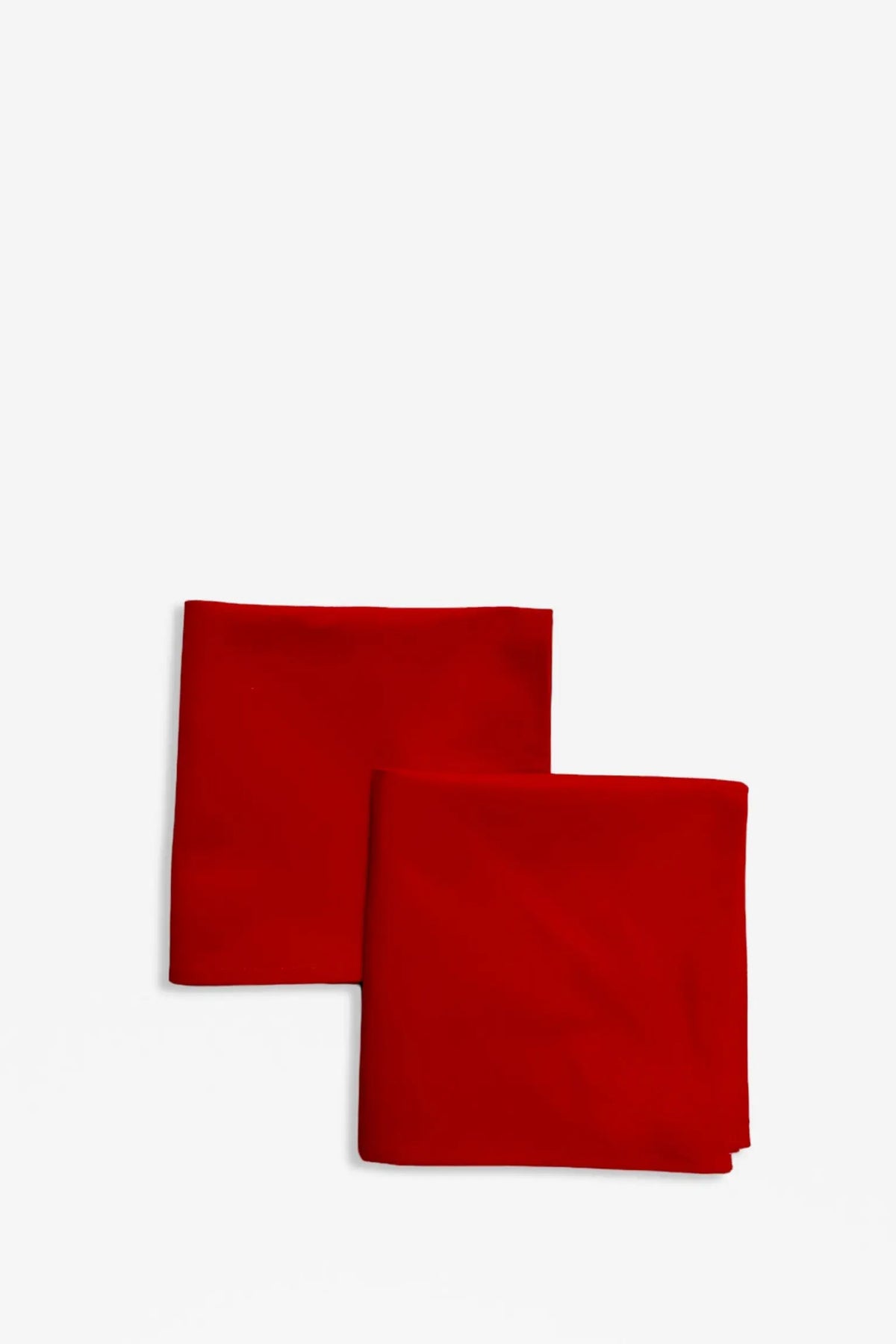 Two square, plain red canvas napkins folded neatly, isolated on a white background.