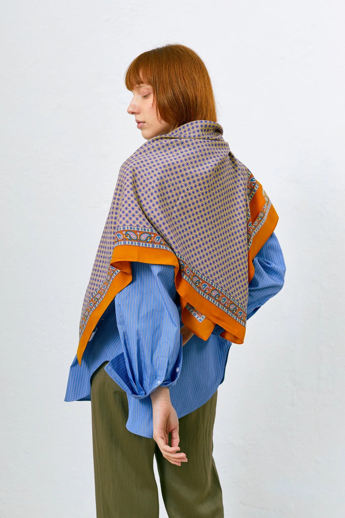 Pañuelo aragonés con estampado geométrico azul y detalles de cachemir sobre base marrón anaranjada.