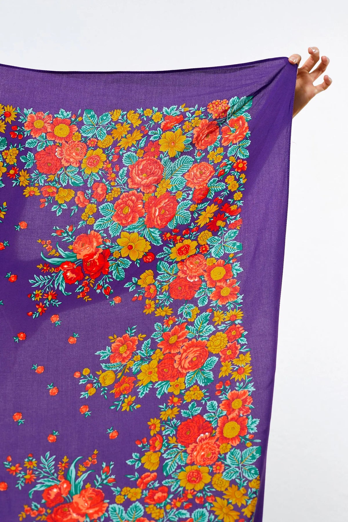 Purple scarf featuring a vibrant, traditional Portuguese floral pattern with orange, red, and yellow blossoms.