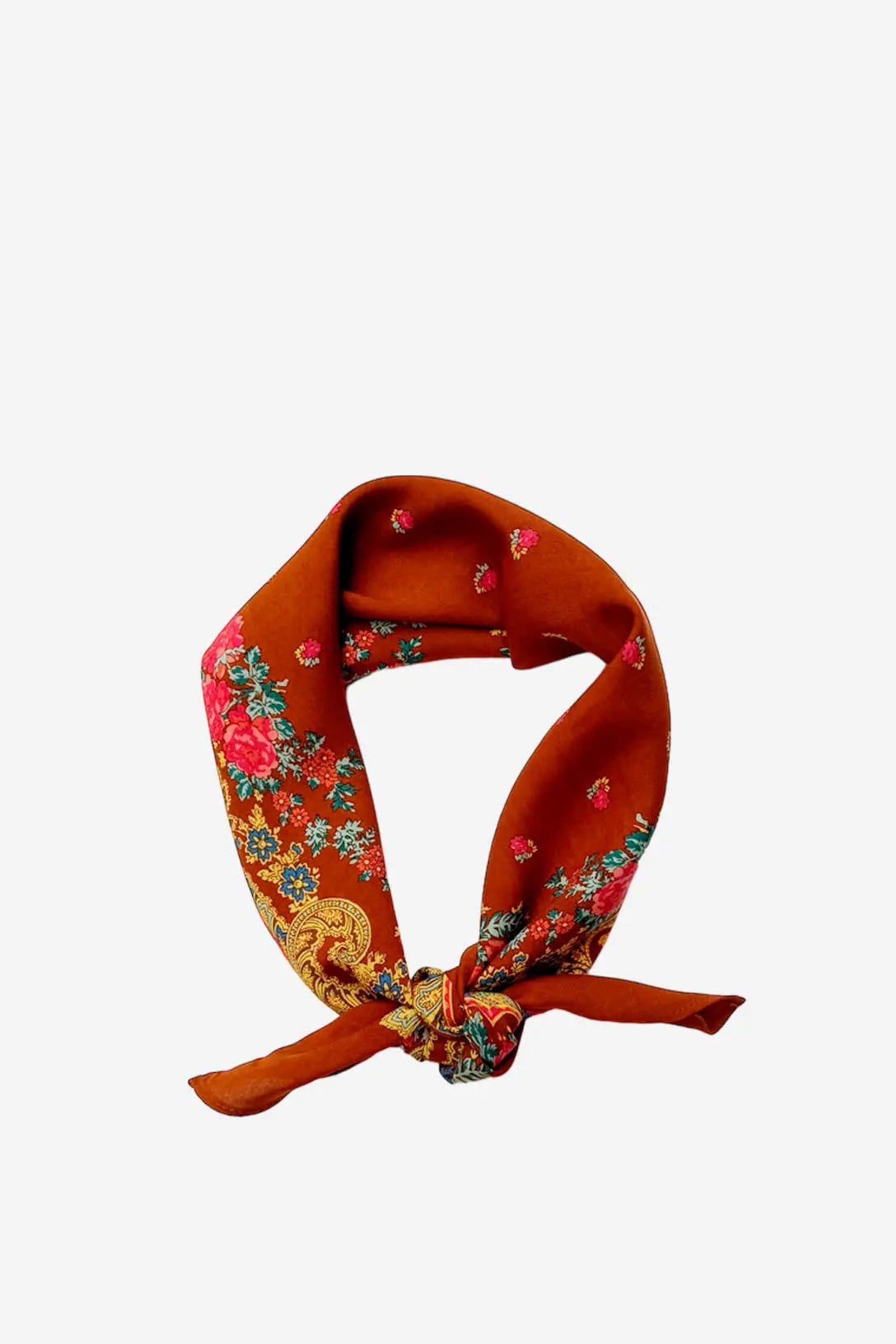 Rust-orange silk square scarf with a floral and ornate gold chain print, tied in a knot, isolated on white.