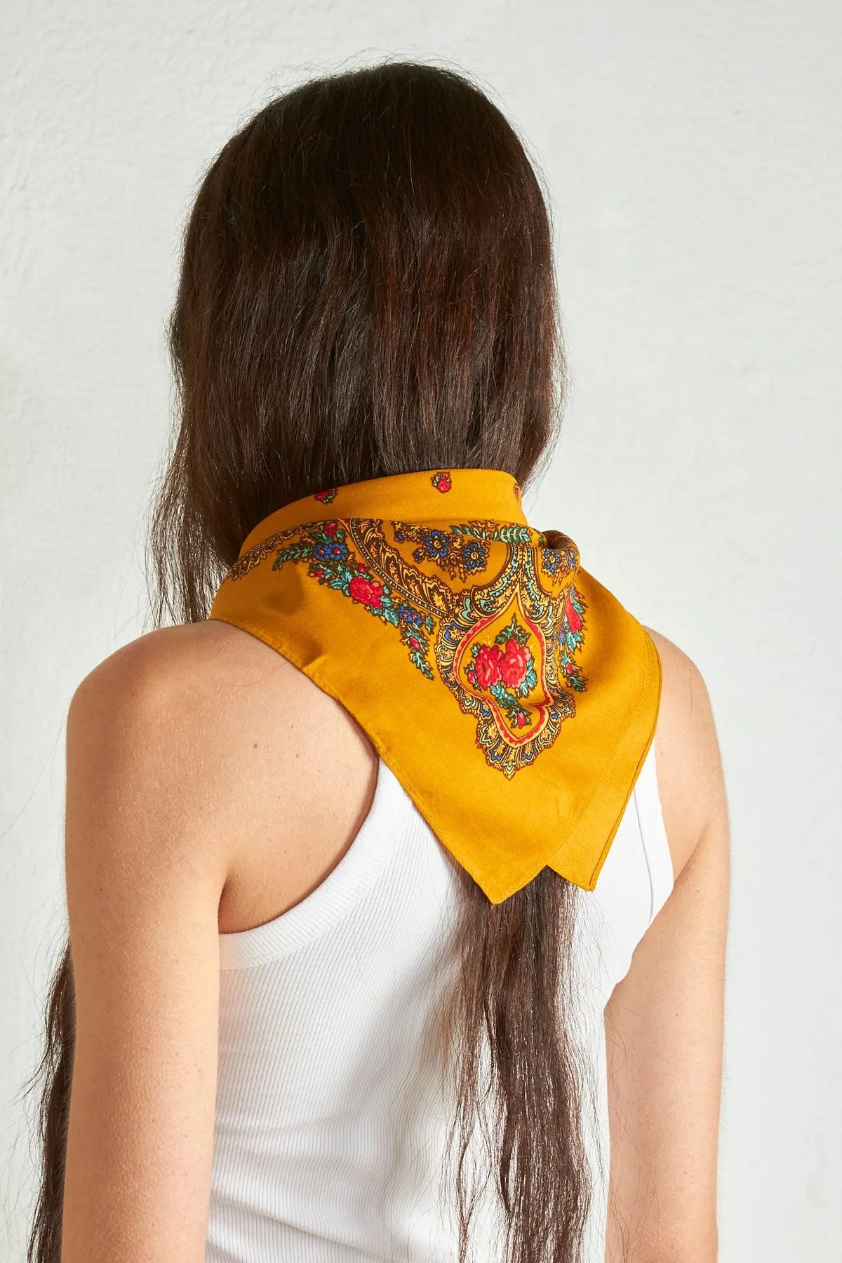 Ochre Portuguese-style triangular headscarf with traditional floral and chain-link patterns in red, blue, and gold.