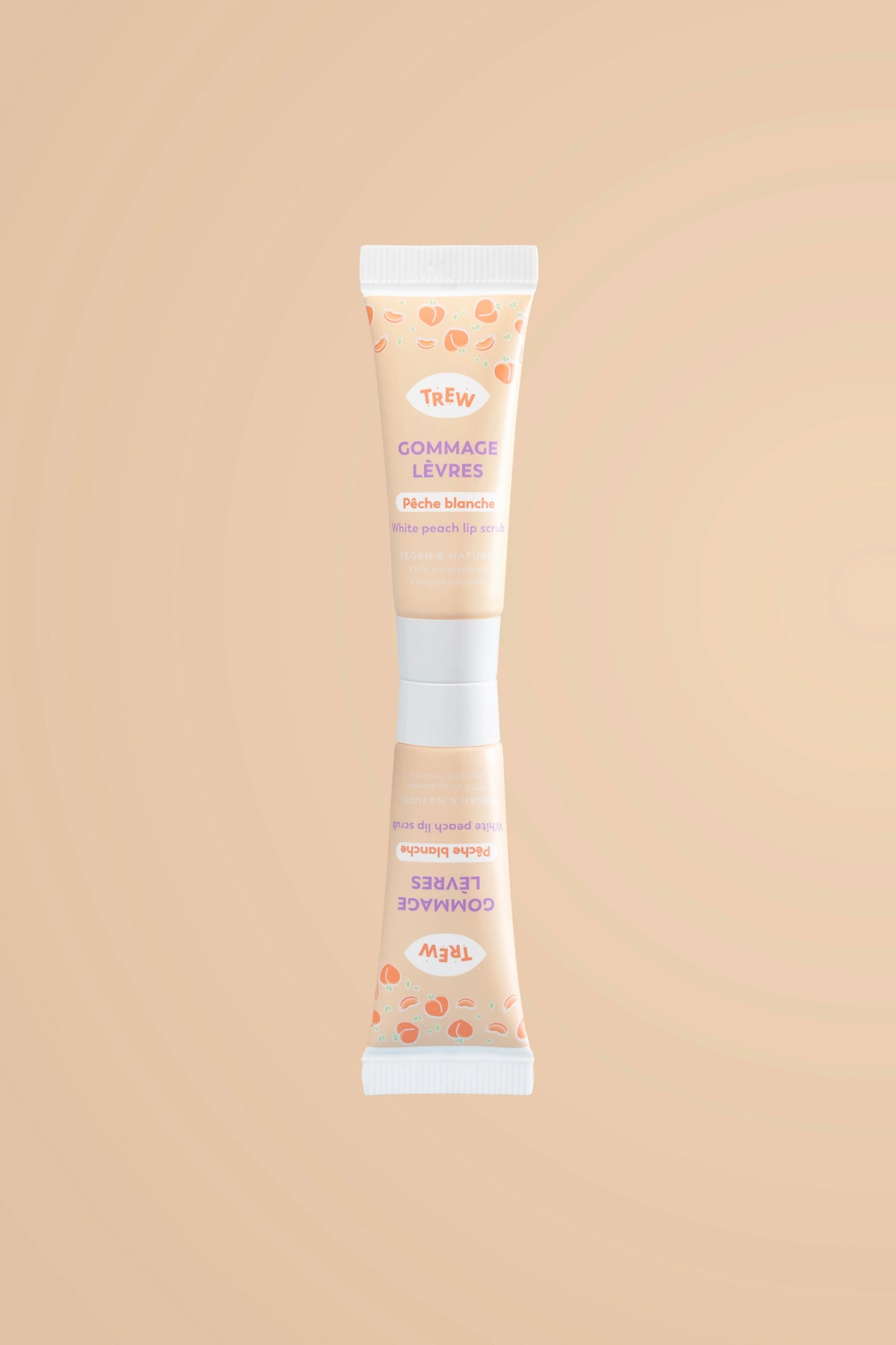 Tube de gommage lèvres Trew pêche blanche, fond beige, motifs pêches, inscription violette, design épuré et moderne.