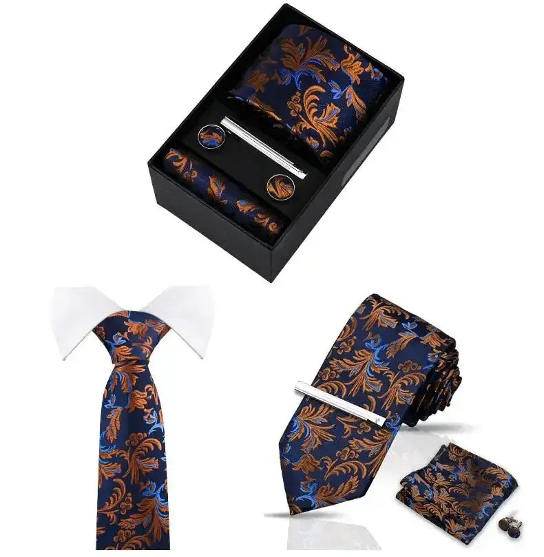 Set de accesorios azul y naranja con estampado paisley: corbata, pañuelo, gemelos y pasador plateado en caja negra.