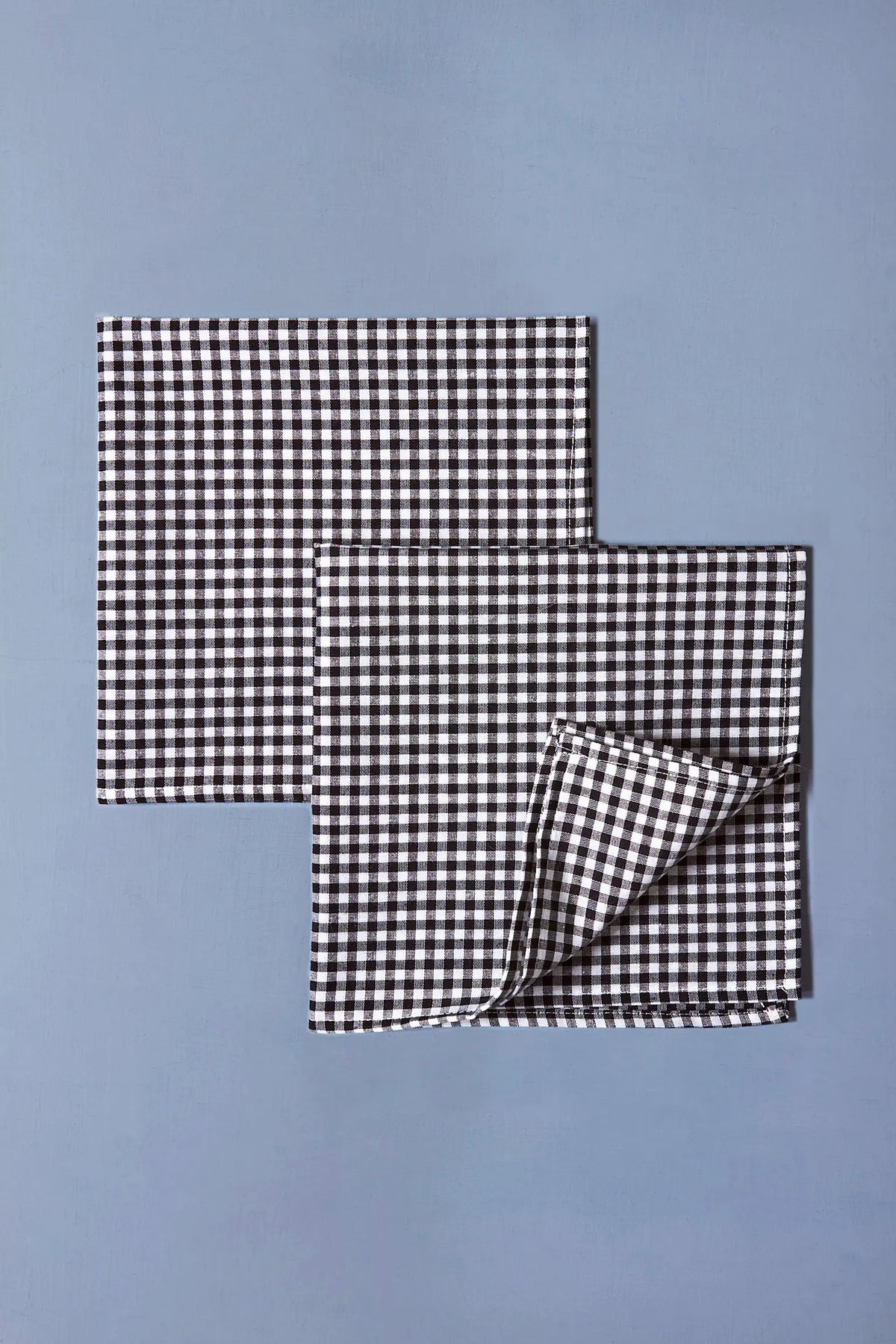 Pack de dos servilletas de tela con estampado de cuadros vichy en blanco y negro, estilo rústico y elegante.