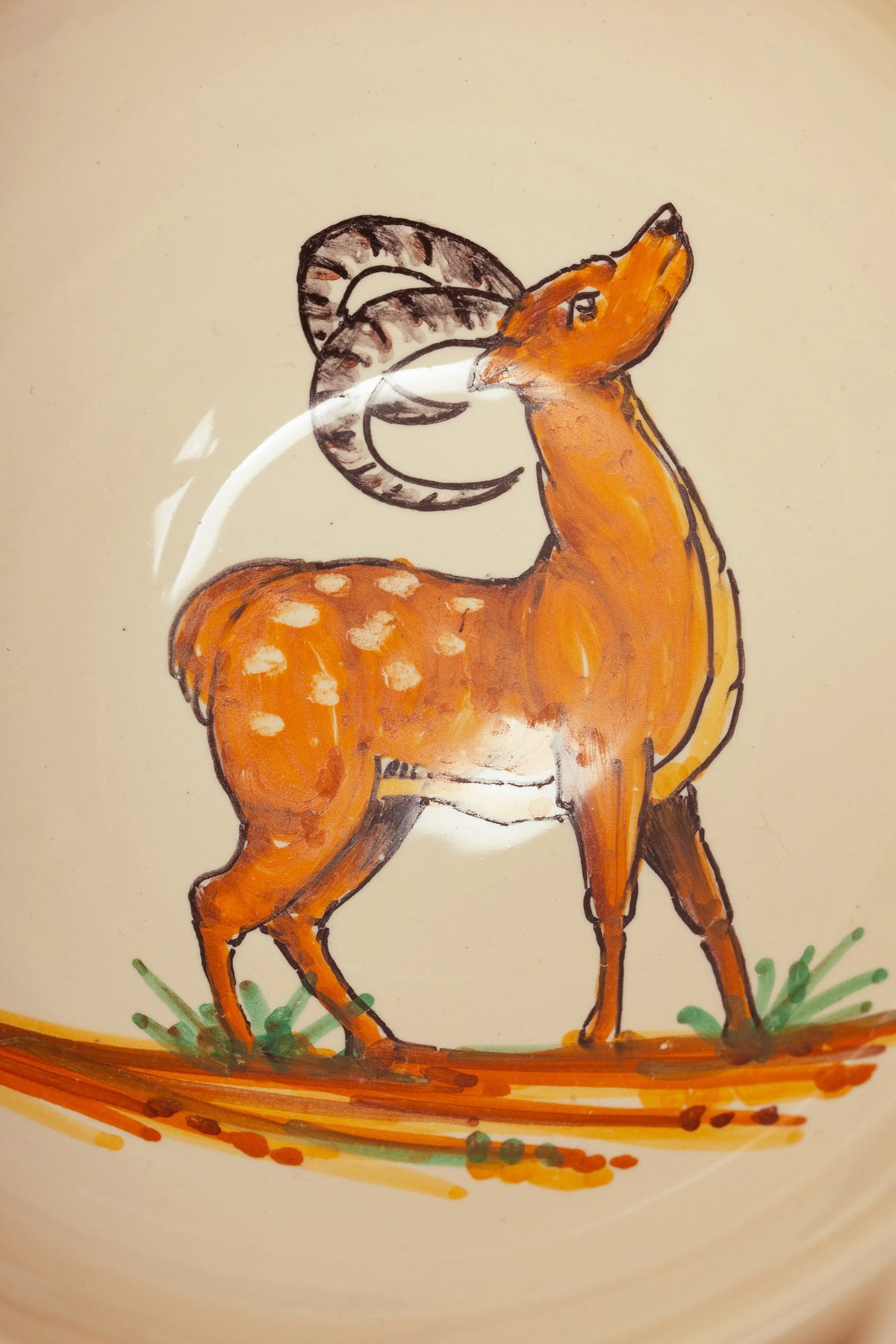 Cuenco de cerámica color crema con ilustración artesanal de una cabra montés en tonos ocres y detalles de vegetación.