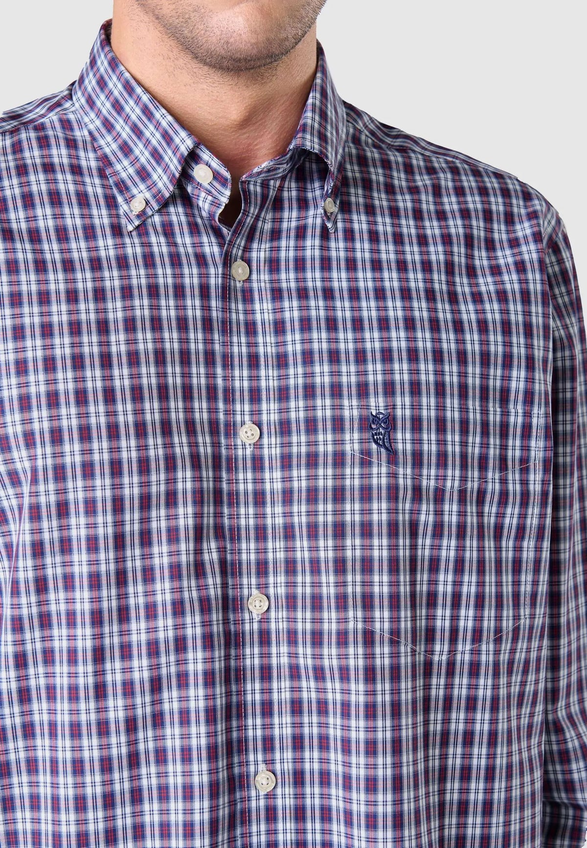 Camisa de hombre de manga larga en popelín con estampado de cuadros rojos y azules, ajuste clásico y bolsillo frontal.