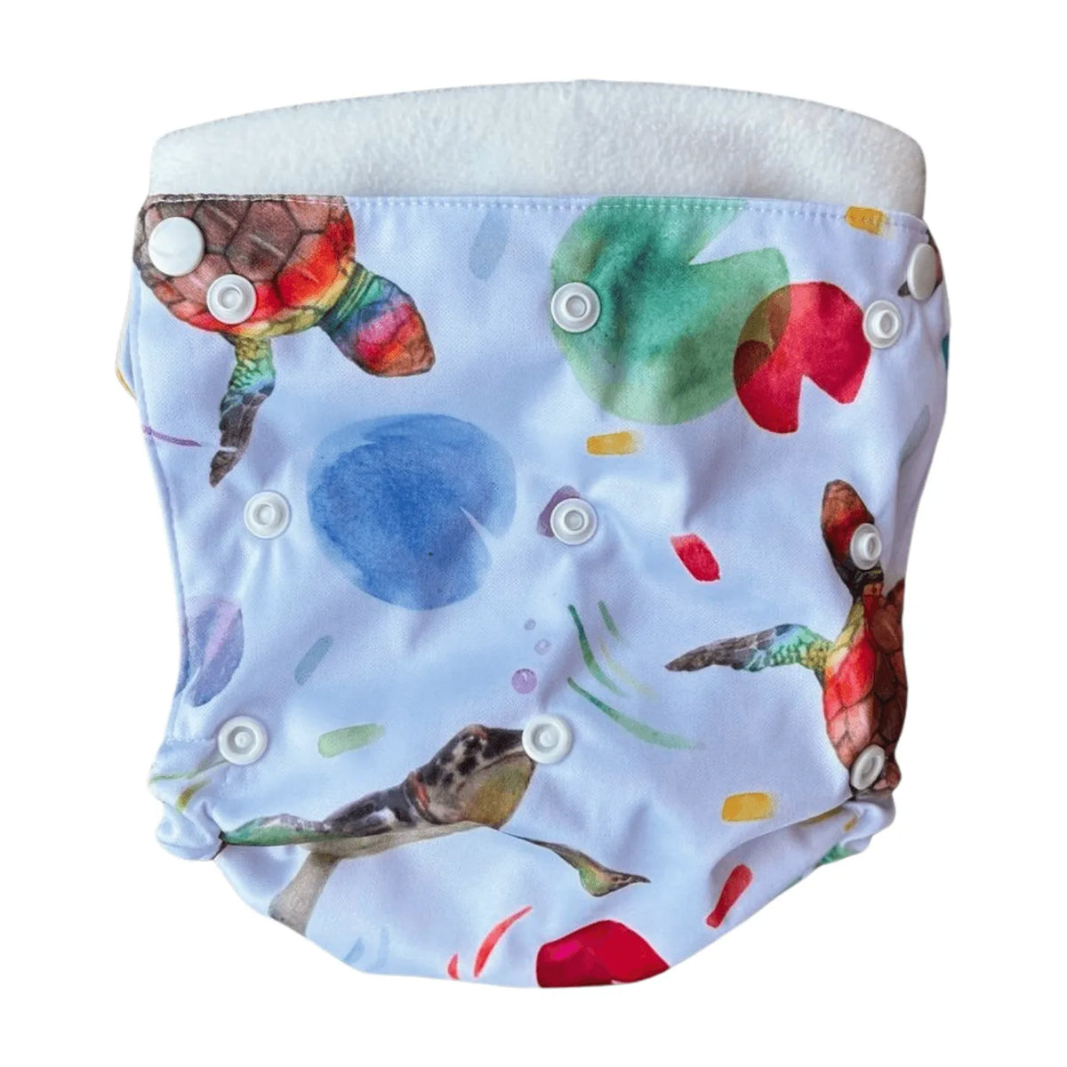 All-in-two diaper cover with white snaps, featuring a watercolor sea turtle and lily pad print on light blue fabric.