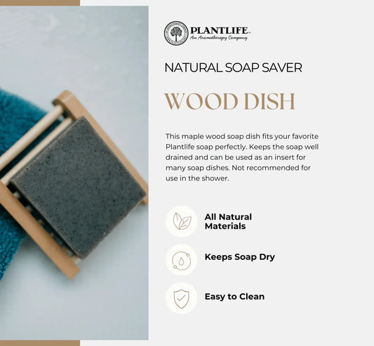 Rectangular maple wood slated soap dish holding a square gray soap bar, resting on a blue textured cloth.