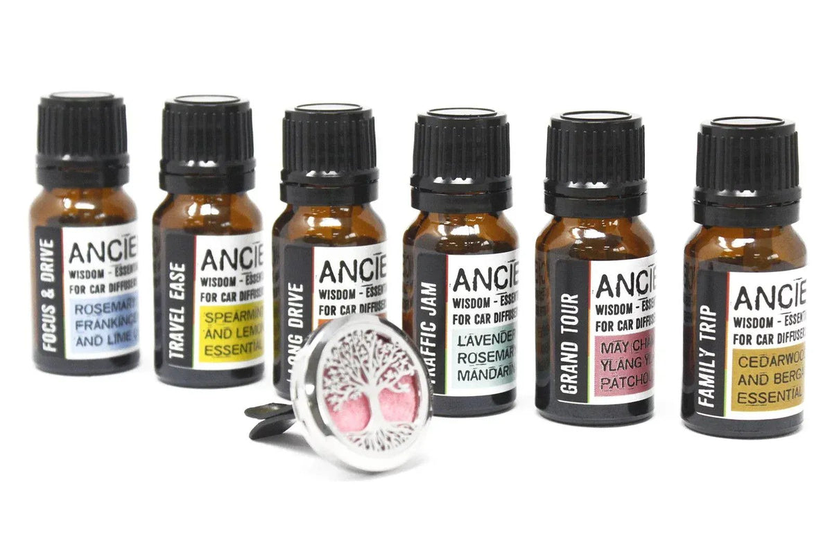 Seis frascos de vidrio ámbar con aceites esenciales para coche y un difusor metálico con diseño de árbol de la vida.