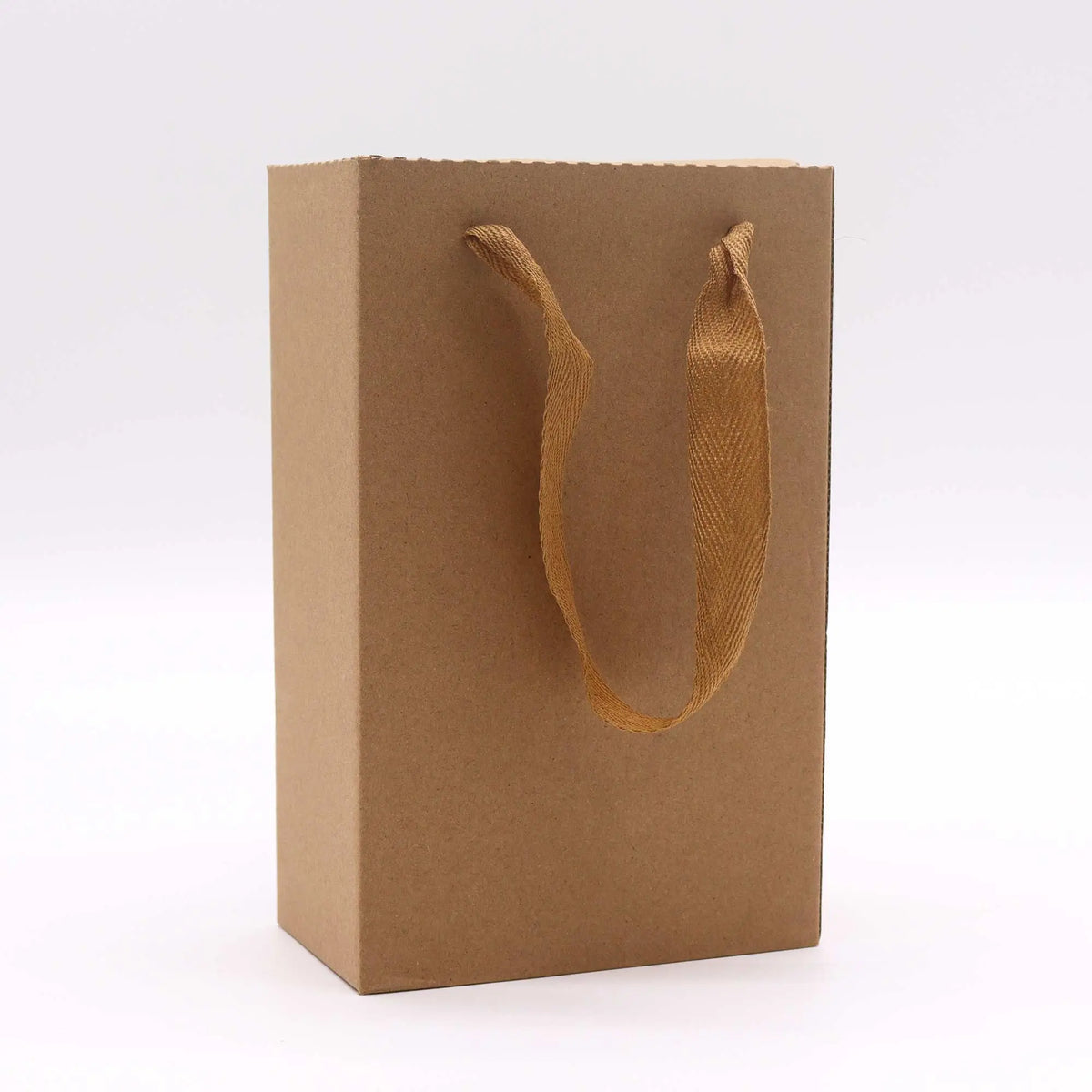Bolsa de regalo de cartón color café con asas de tela para empaque de set de tetera premium en color naranja