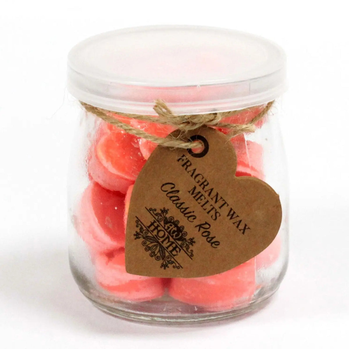 Frasco de cristal con cera de soja rosa en forma de corazones, tapa blanca y etiqueta artesanal de papel kraft