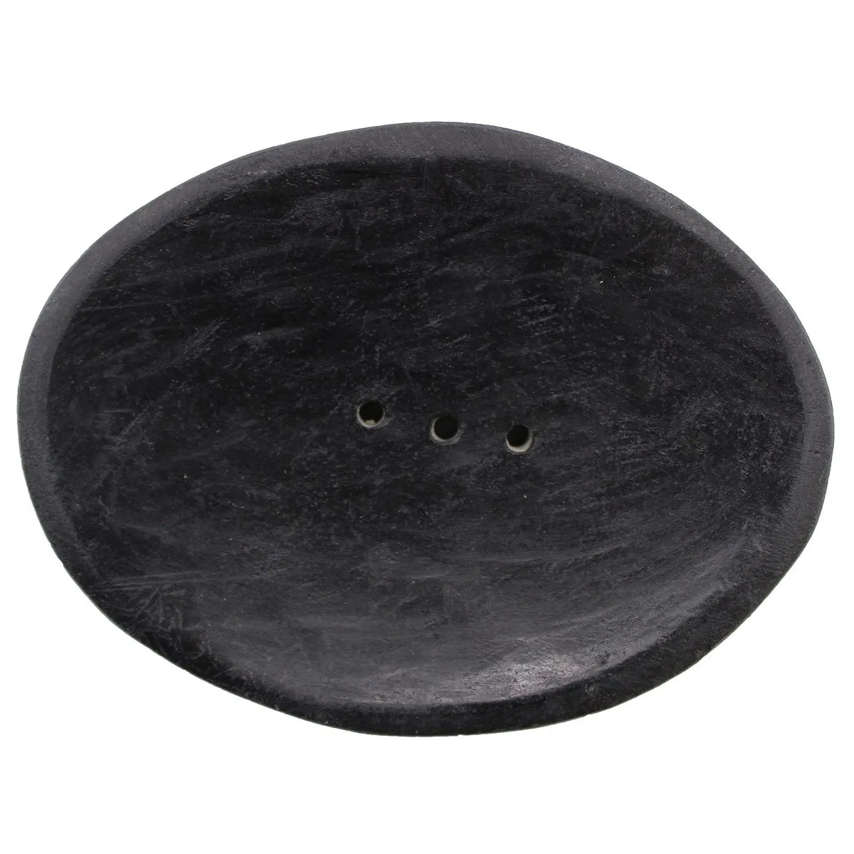 Jabonera ovalada de piedra natural negra con superficie texturizada y tres pequeños orificios de drenaje al centro.