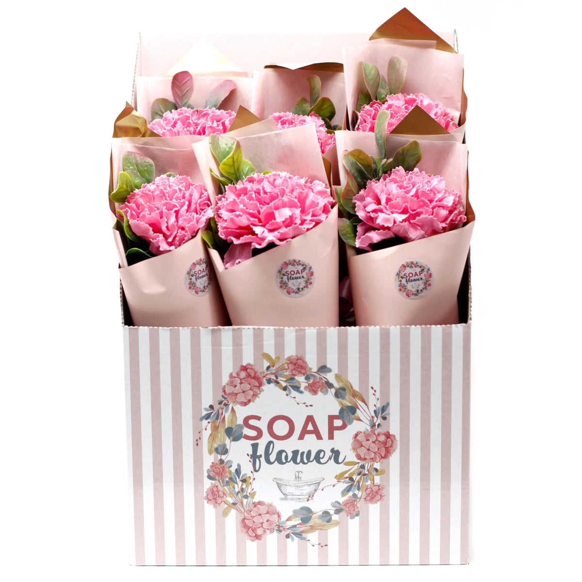 Caja expositora con ramos de claveles rosas hechos de jabón, envueltos en papel decorativo color rosa suave.