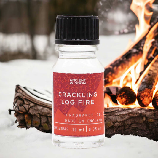 Frasco de vidrio de 10ml con tapa negra frente a una fogata sobre nieve. Etiqueta roja con texto blanco.