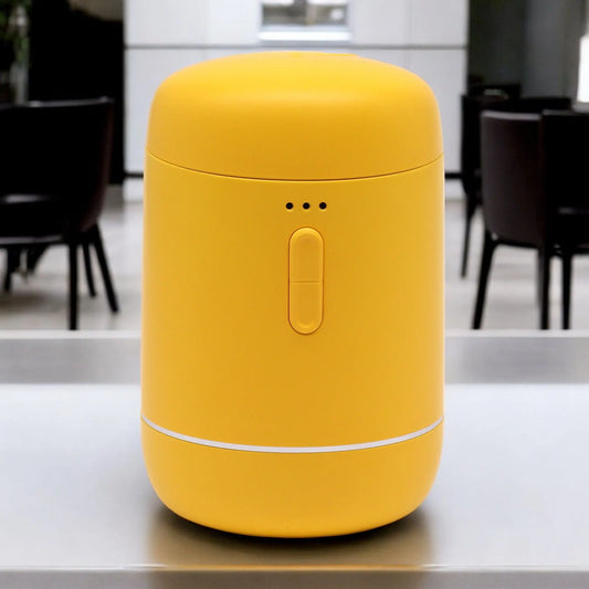 Difusor de aromas amarillo, cilíndrico, sin agua, con puerto USB-C y botón de control. Diseño moderno y minimalista.