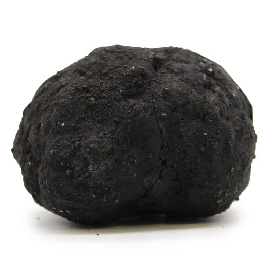 Piedra de carbón negra, textura rugosa y irregular, ideal para parrillas y chimeneas.