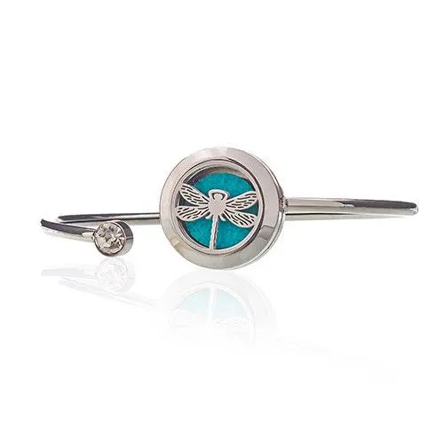 Pulsera de plata con diseño de libélula y piedra turquesa, detalle de cristal. Estilo moderno y elegante.