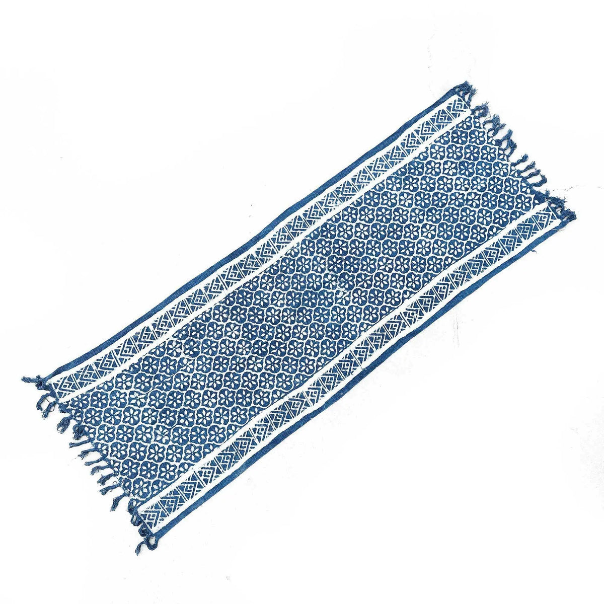 Mantel azul marino de algodón con diseño geométrico blanco y flecos, ideal para decoración rústica.