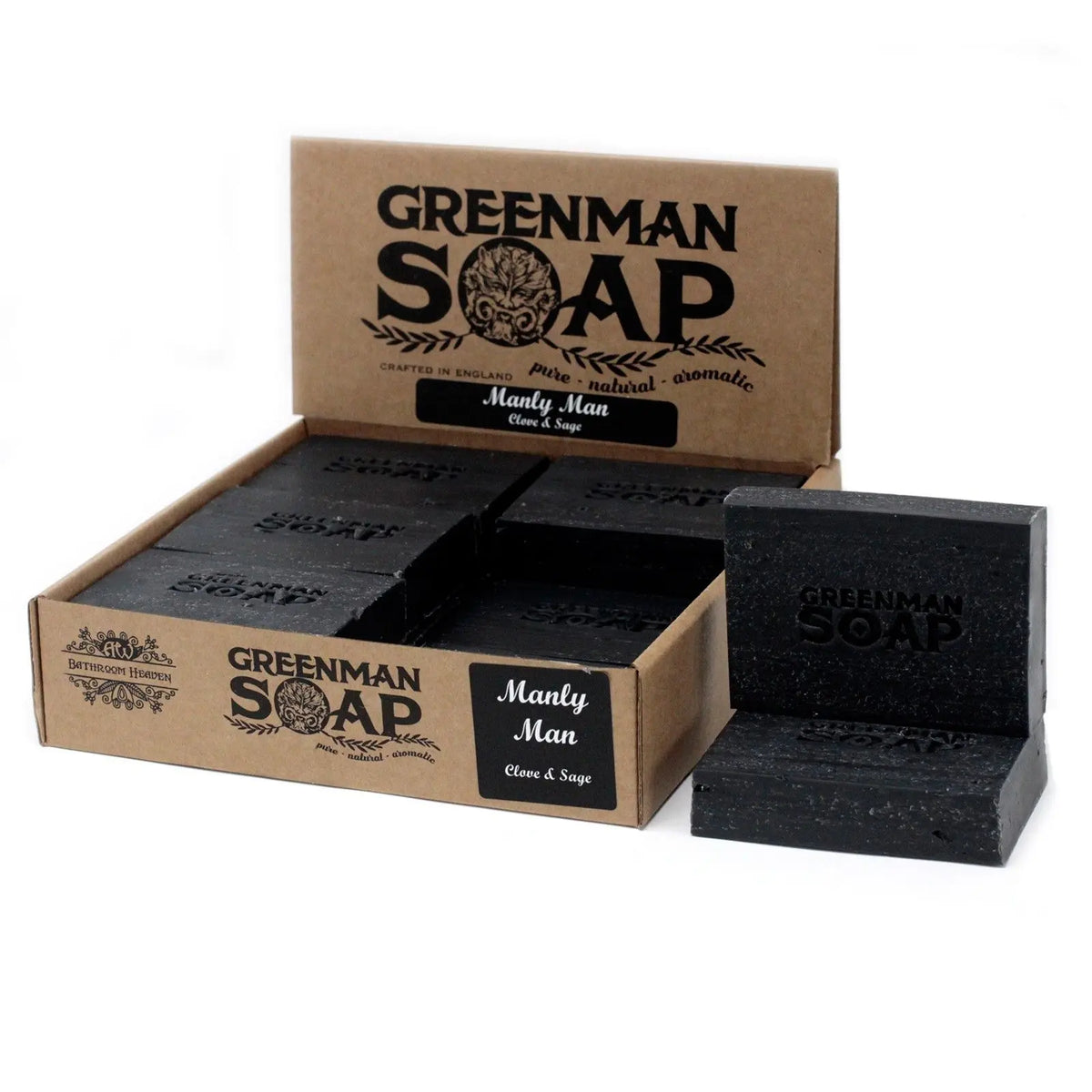 Pastillas de jabón rectangulares negras en una caja expositora de cartón kraft con texto y diseño rústico.