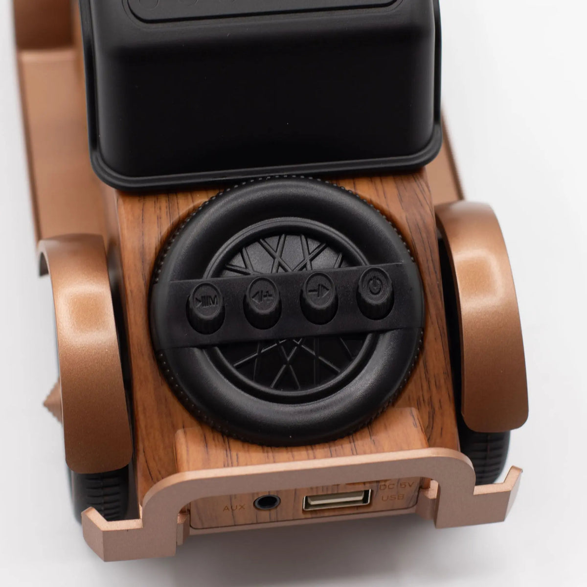 Altavoz Bluetooth vintage: diseño de coche en madera y bronce con controles sobre rueda de repuesto y puertos USB/AUX.