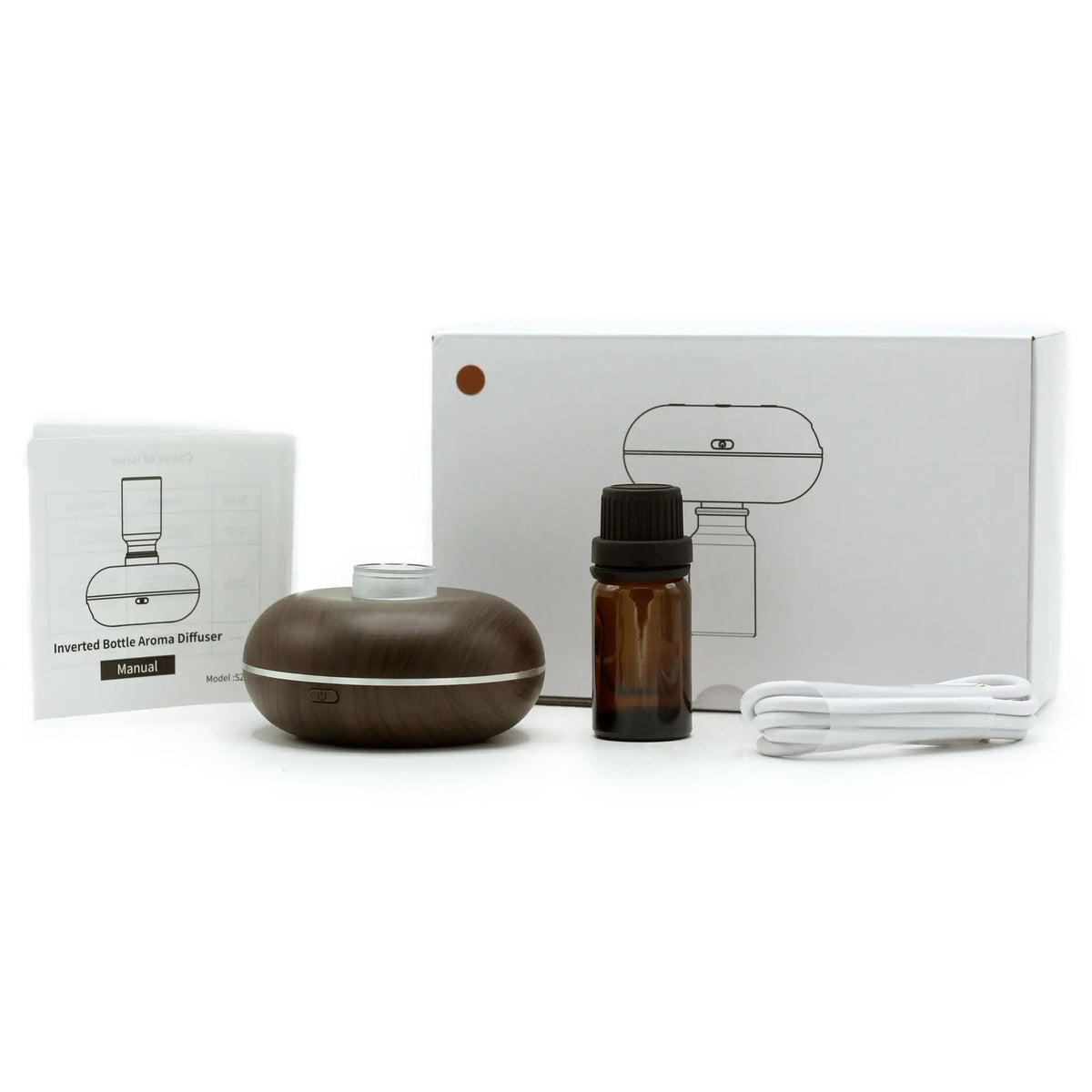 Mini difusor de aroma madera oscura, manual, frasco vacío, cable USB y caja blanca sobre fondo blanco.