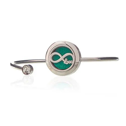 Pulsera de acero inoxidable con charm de infinito en verde y cristal, estilo moderno y elegante.