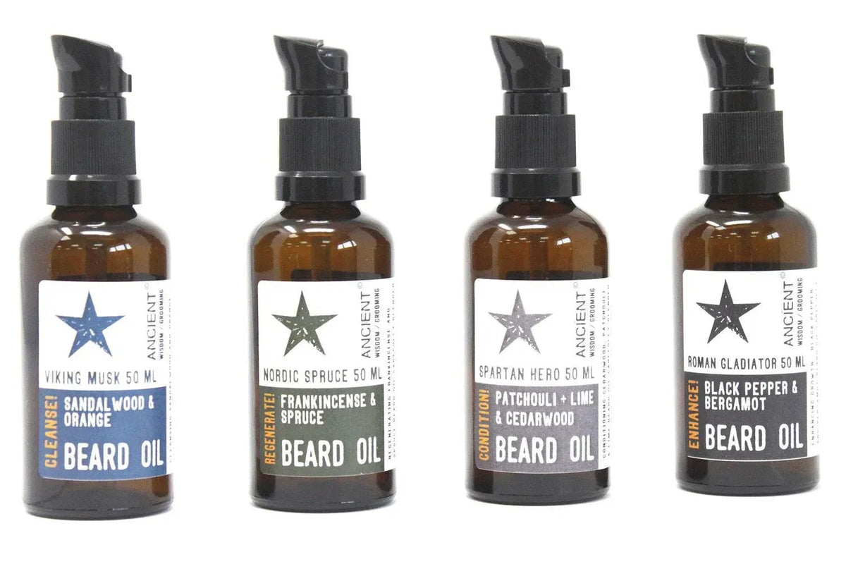 Cuatro frascos de vidrio ámbar de 50ml con dosificador negro y etiquetas de colores Ancient Wisdom para aceite de barba.
