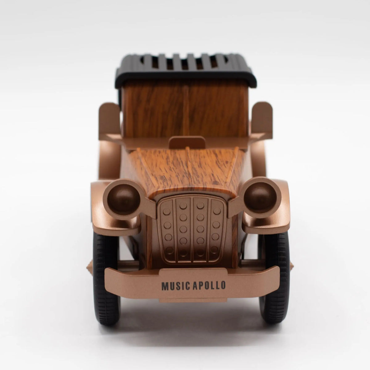 Altavoz Bluetooth vintage con forma de coche clásico, acabado en madera y metal bronce, con soporte para teléfono.