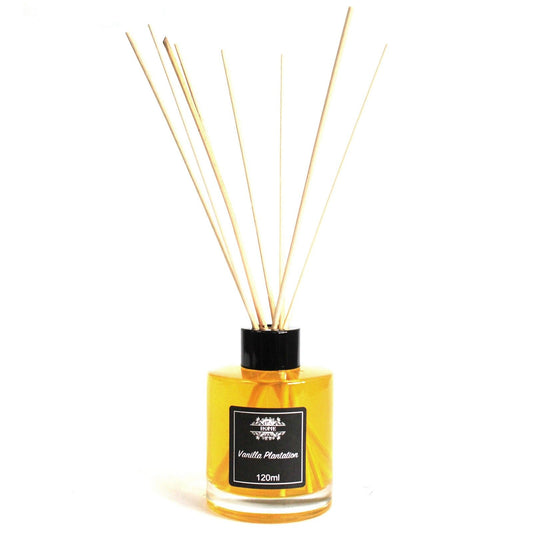 Difusor aromático de 120ml con varillas de madera en frasco de vidrio cilíndrico transparente con líquido amarillo.