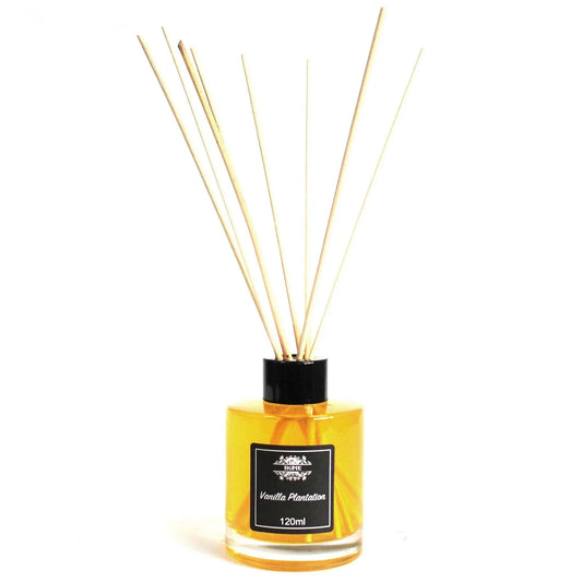 Difusor aromático de 120ml con varillas de madera en frasco de vidrio cilíndrico transparente con líquido amarillo.