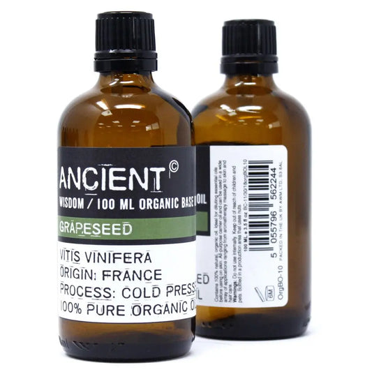 Dos frascos de vidrio ámbar de 100ml con tapa negra, etiquetas blancas y contenido de aceite base orgánico.