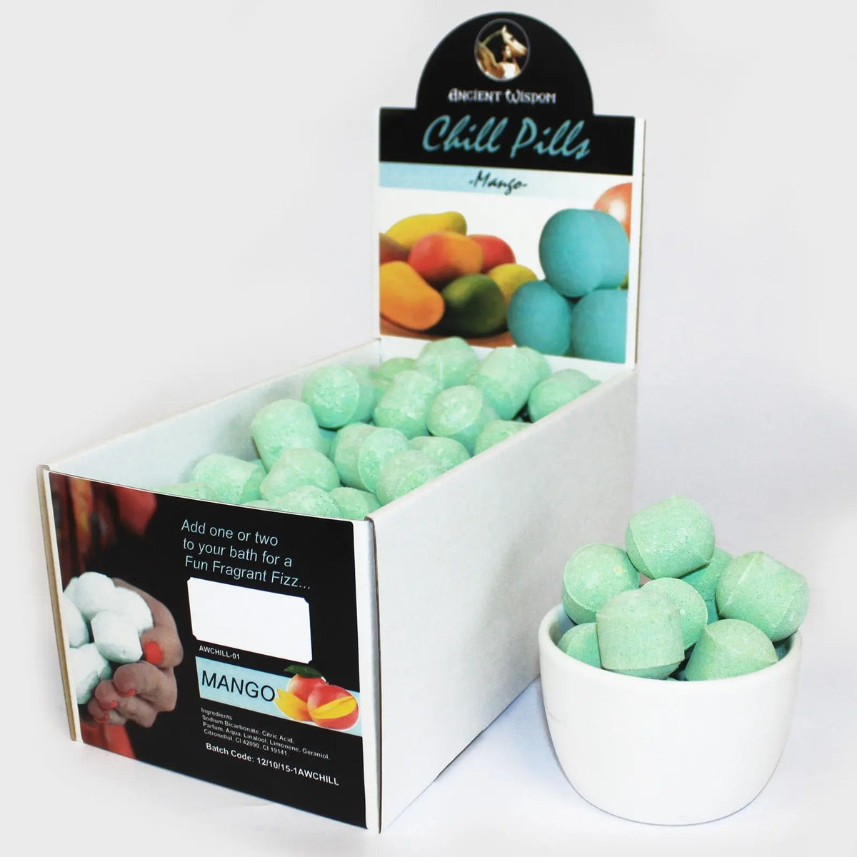 Caja con mini bombas de baño efervescentes color verde menta, forma cilíndrica y aroma a mango tropical.