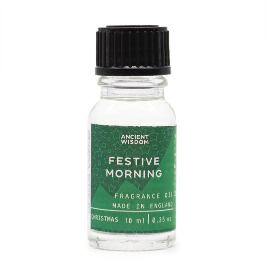 Frasco de vidrio de 10 ml con tapón negro y etiqueta verde con estrellas y texto "Festive Morning". Fondo blanco.