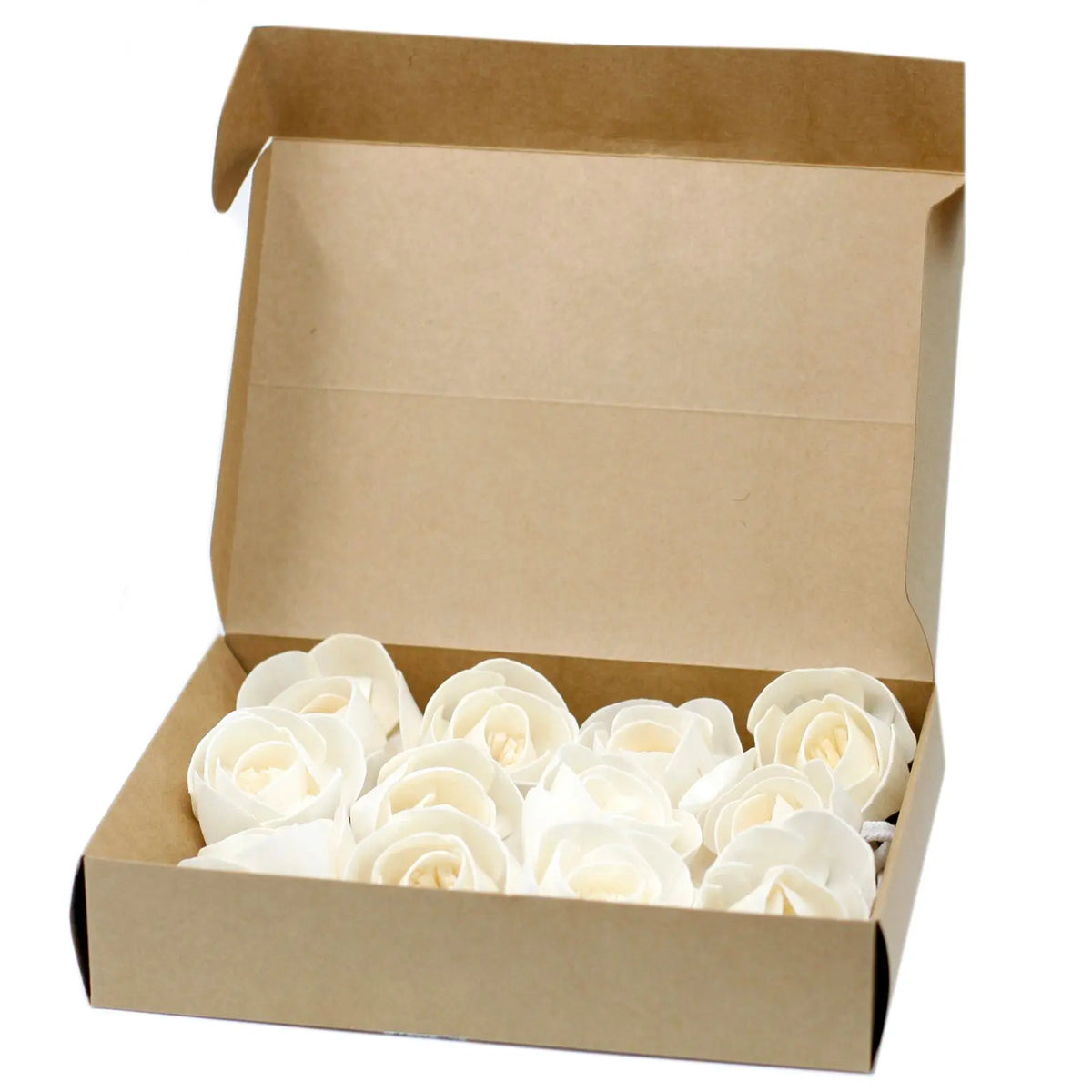 Caja de cartón kraft abierta conteniendo flores difusoras de madera color crema en forma de rosa con cuerda.