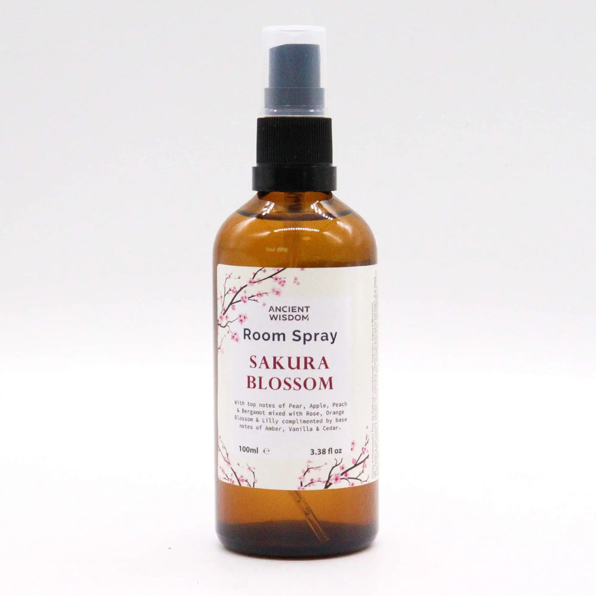 Spray de ambiente de 100ml en botella de vidrio ámbar con etiqueta de flores de cerezo sobre fondo blanco.