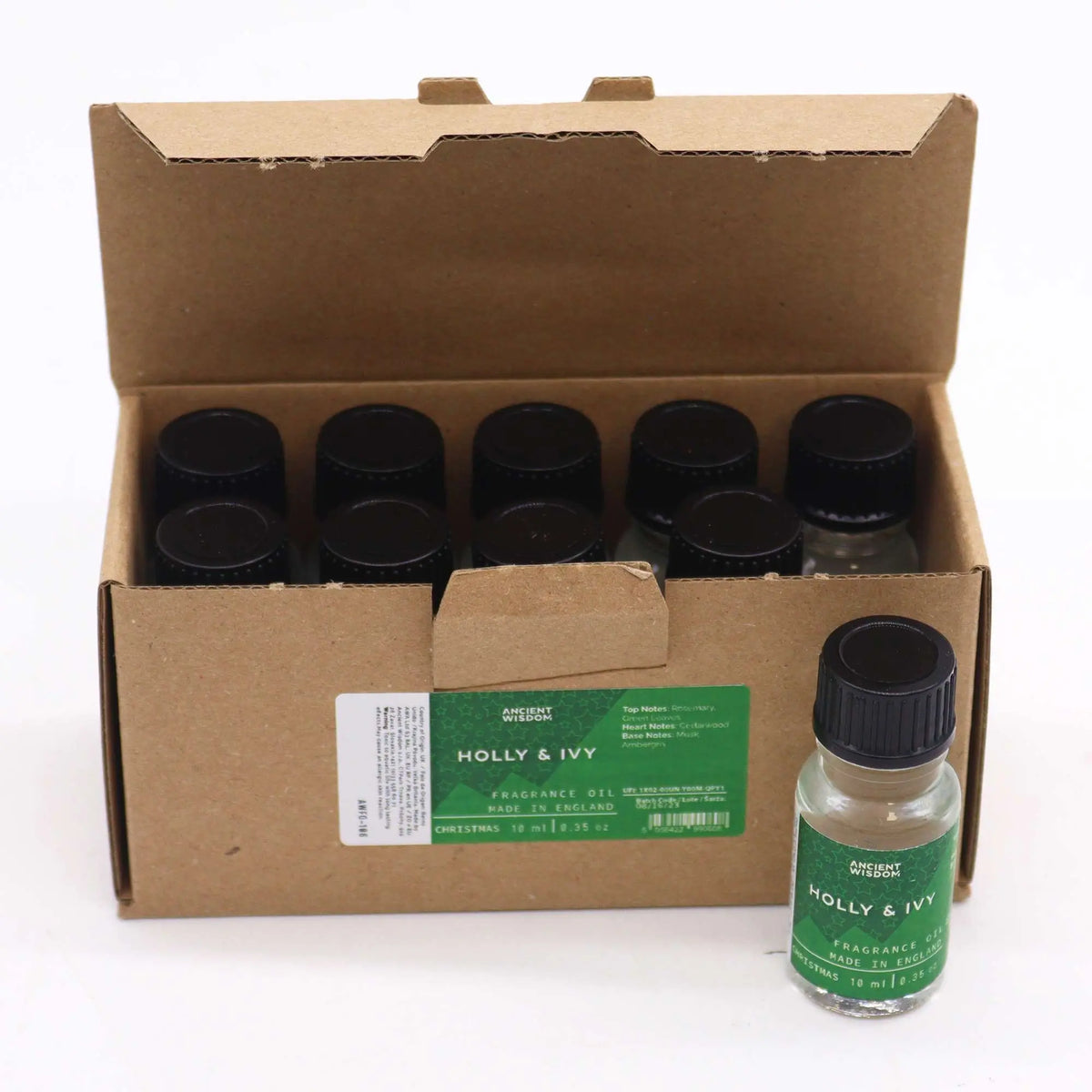 Caja de cartón con frascos de vidrio de 10ml, tapa negra y etiqueta verde de aceite aromático Acebo y Hiedra.