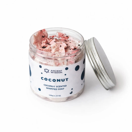 Jabón batido de coco, 120g, en frasco transparente con tapa plateada, aroma fresco y textura cremosa.