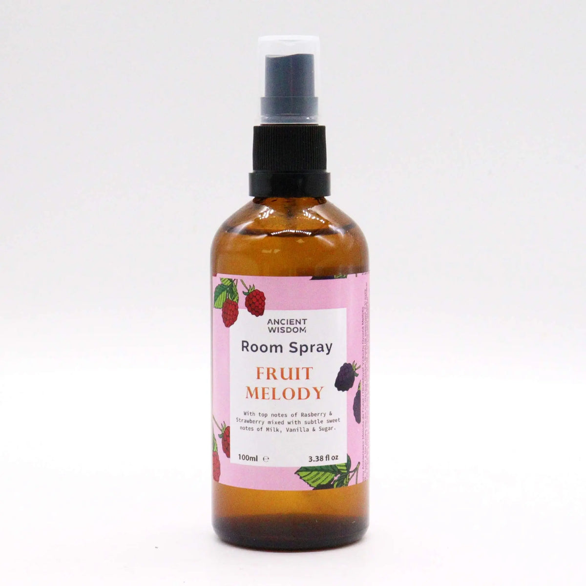 Spray de ambiente de 100ml en botella de vidrio ámbar con etiqueta rosa ilustrada con frutas, sobre fondo blanco.
