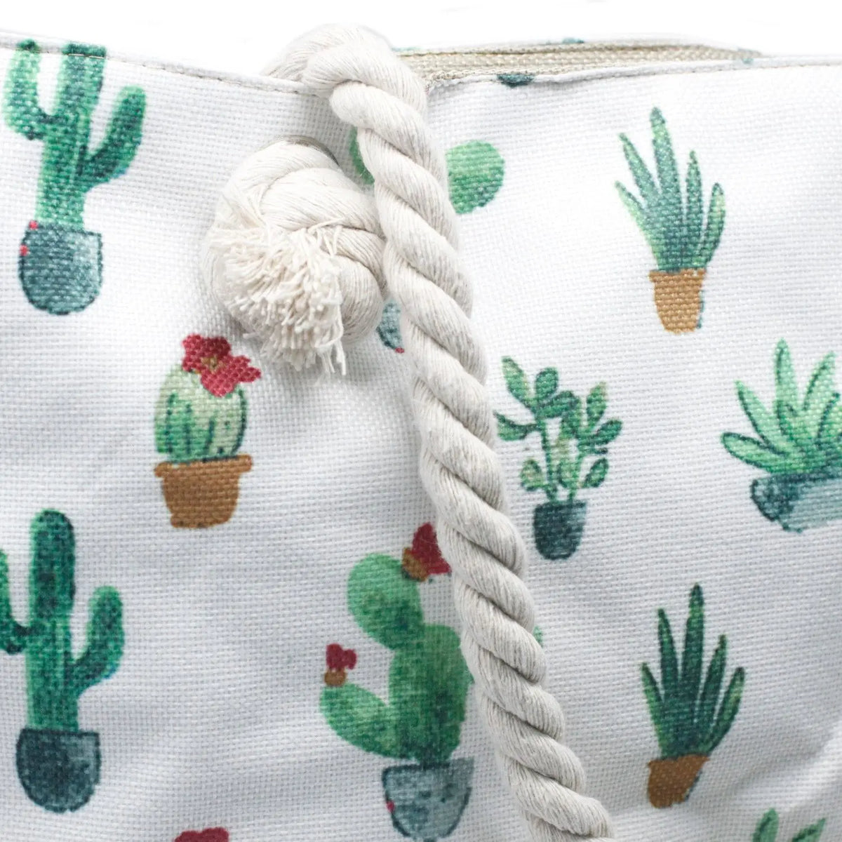 Bolso shopper de tela blanca con estampado de cactus y asa de cuerda gruesa color beige anudada.