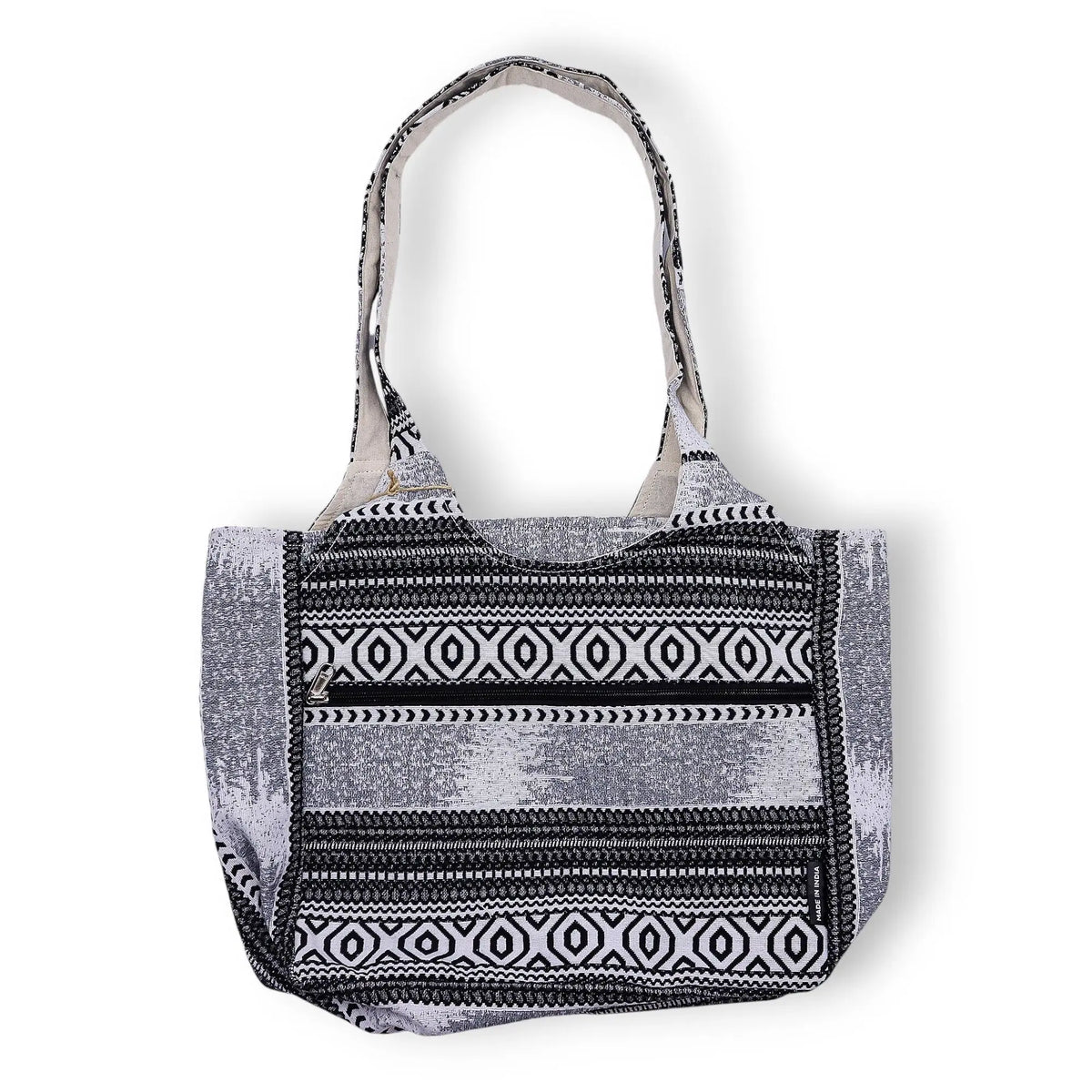 Bolso tote de tela en blanco y negro con diseño geométrico, asas largas y estilo bohemio. Ideal para uso diario.