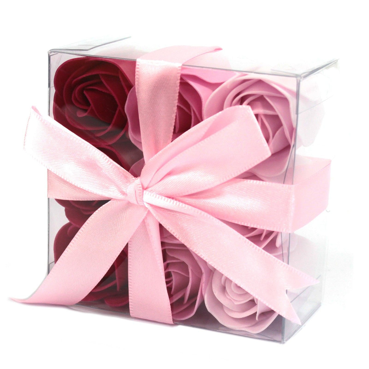Caja transparente con nueve rosas de jabón en tonos rosa y burdeos decorada con un elegante lazo de satén rosa claro