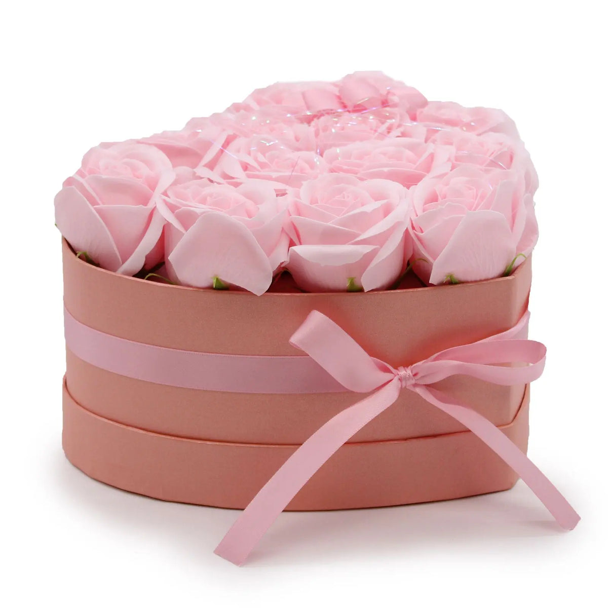 Caja rosa en forma de corazón con 13 rosas de jabón del mismo tono, decorada con un lazo de cinta satinada.