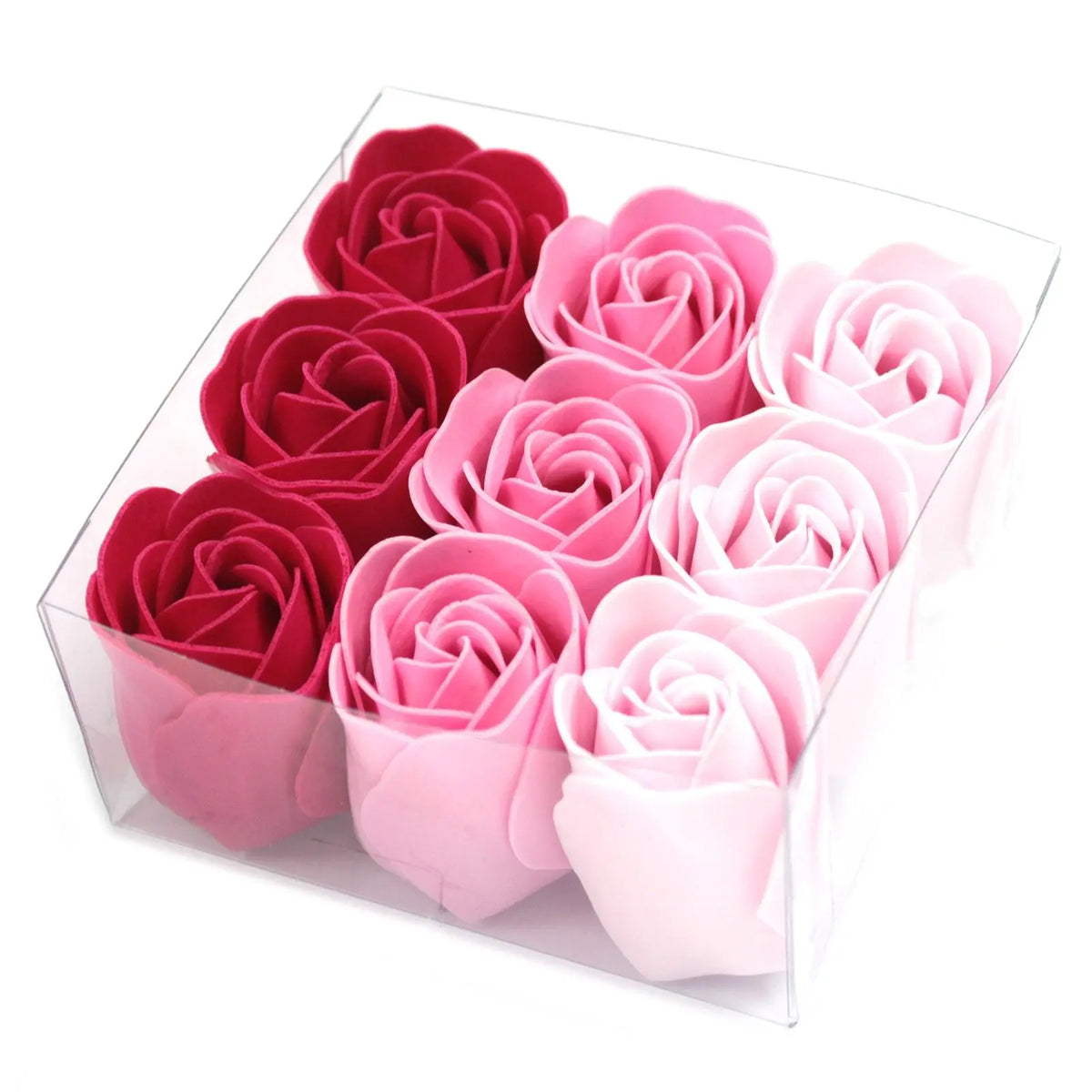 Caja transparente con 9 flores de jabón en forma de rosas con degradado de tonos rosados, dispuestas en tres filas.