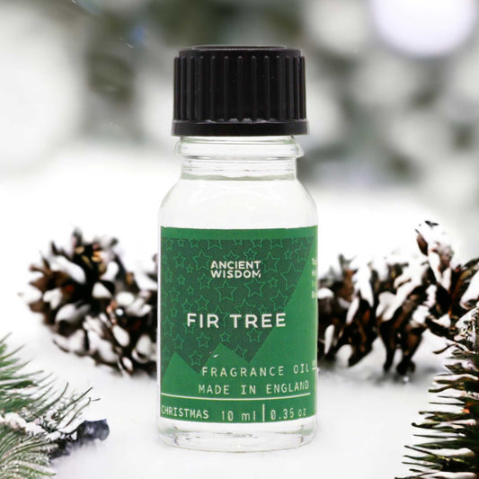 Frasco de cristal de 10ml con tapa negra y etiqueta verde, rodeado de piñas nevadas y ramas de abeto.