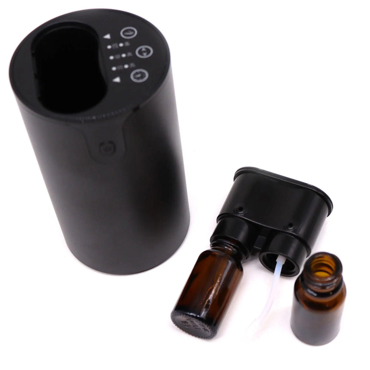 Difusor de aroma negro cilíndrico, sin agua, con dos botes de vidrio ámbar y panel de control táctil superior.